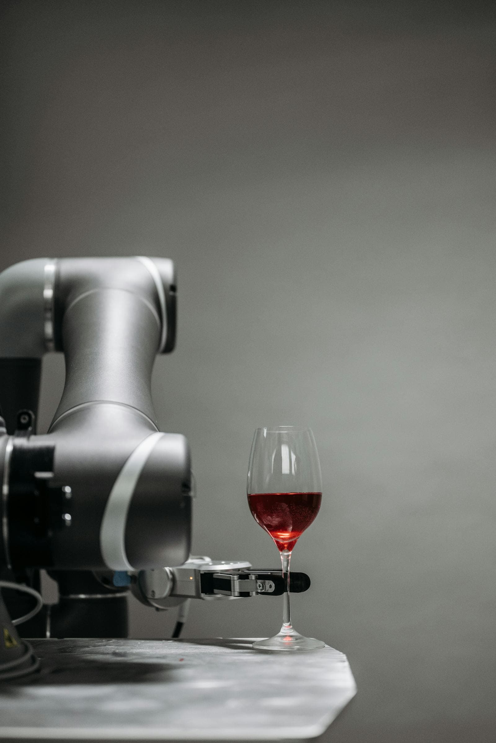 Collaborative robotic arm grasping a cocktail glass